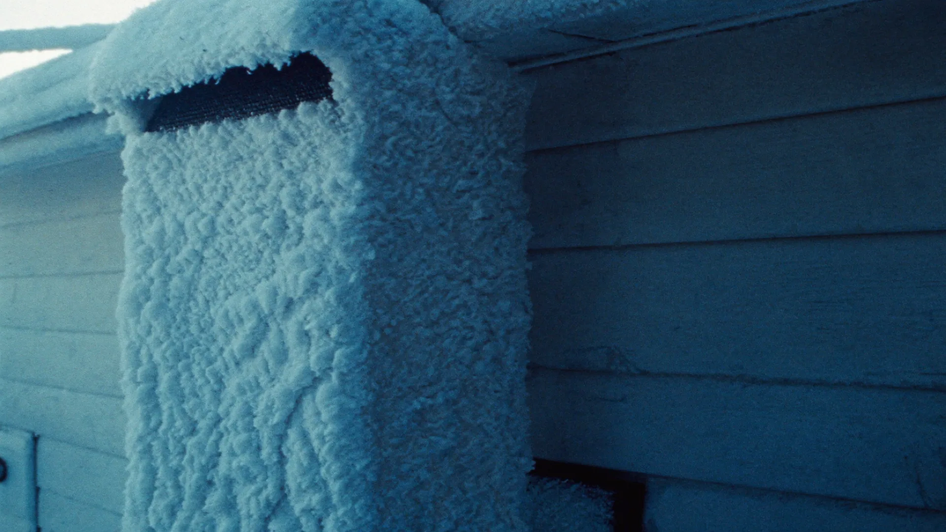 Heavy ice formed on the outside of a home exhaust vent hood